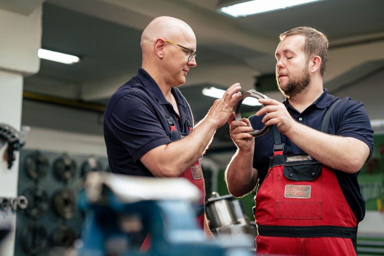 zwei HK Hydraulik Mitarbeiter schauen sich eine Komponente an